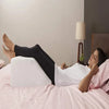 Meddey triangular memory foam bed wedge pillow shown at an angle on a bed