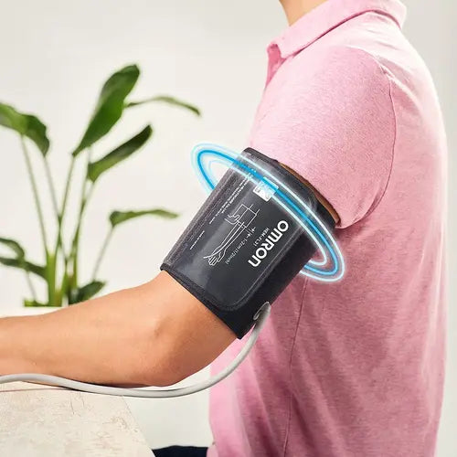 Omron HEM-7156 IntelliWrap blood pressure cuff positioned on the upper arm